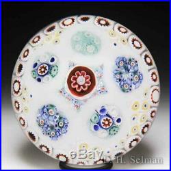 Antique Bacchus patterned millefiori circlets on sodden snow glass paperweight