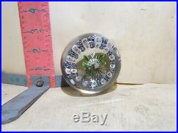 Glass Paperweight With Flower In Center And Alot Of Flowers Around It